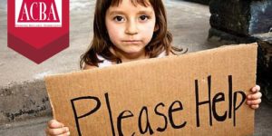 Poverty Workshop - little girl with cardboard sign reading please help