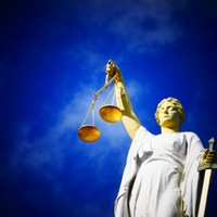 Lady Justice, bright blue sky background